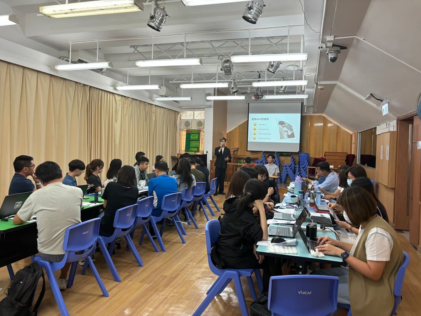 Social workers following a presentation in a hall
