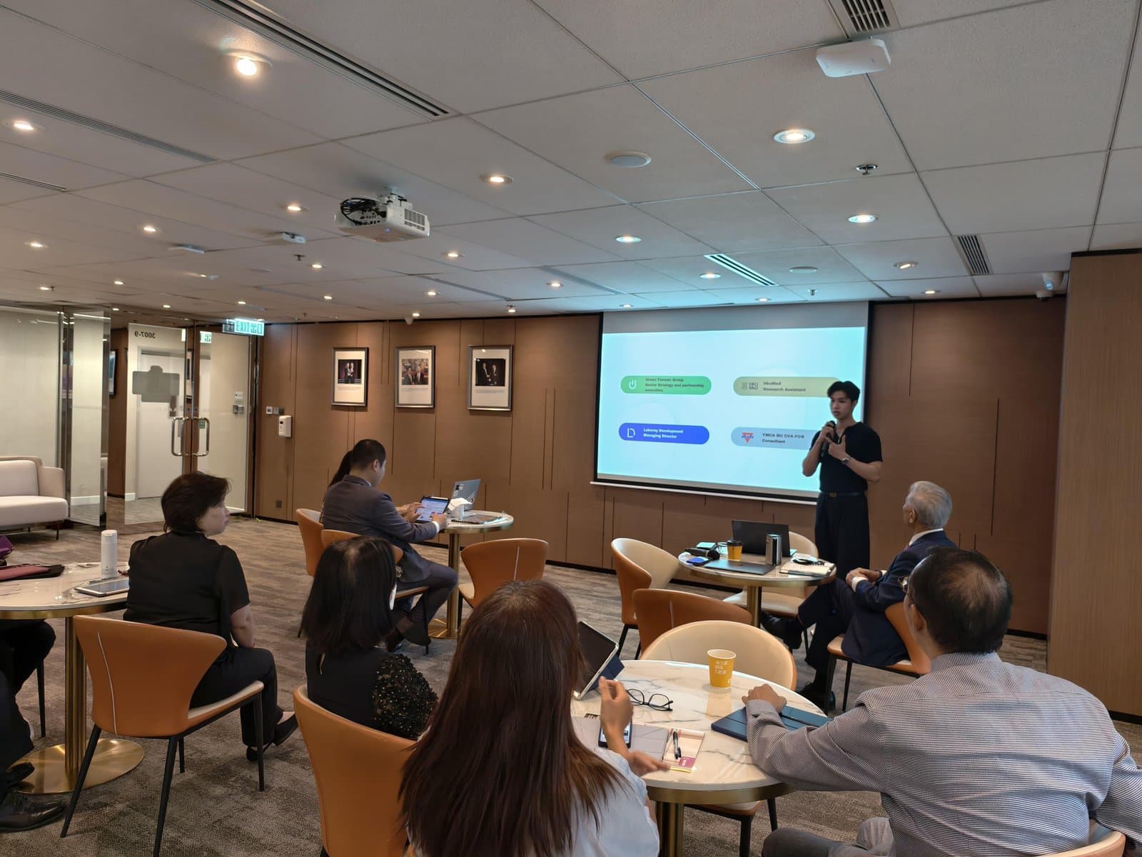 Speaking to a seated audience at the HKAIA sharing session