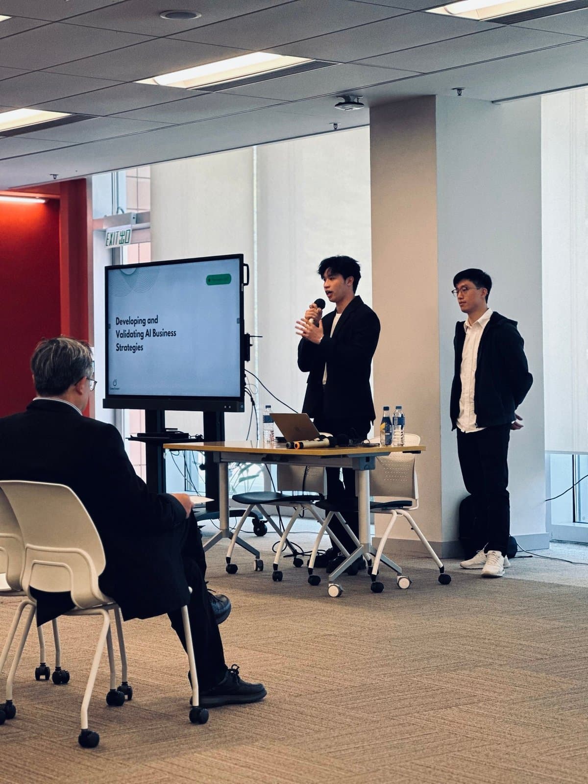 Two speakers presenting AI business strategies at HSUHK